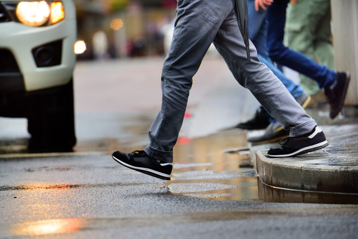 Pedestrian about to walk on street