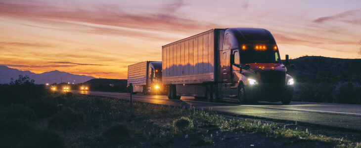 Semi trucks traveling at night