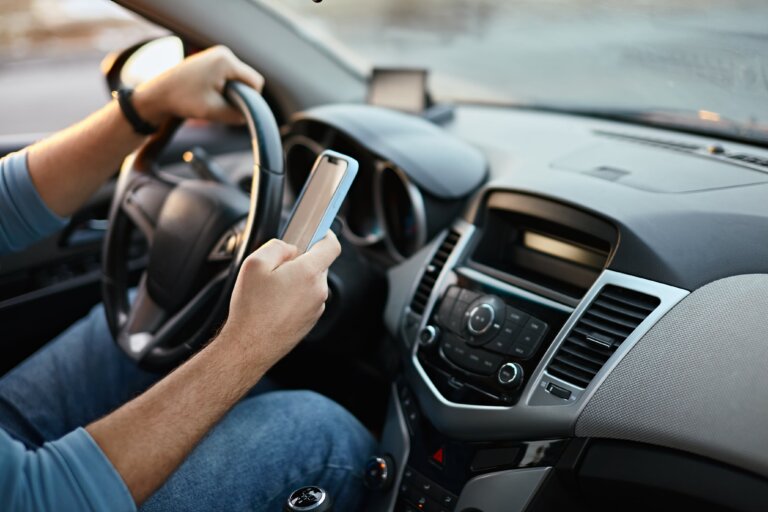 man on his phone while driving