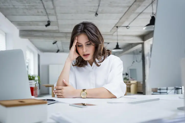 Upset employee sitting at desk